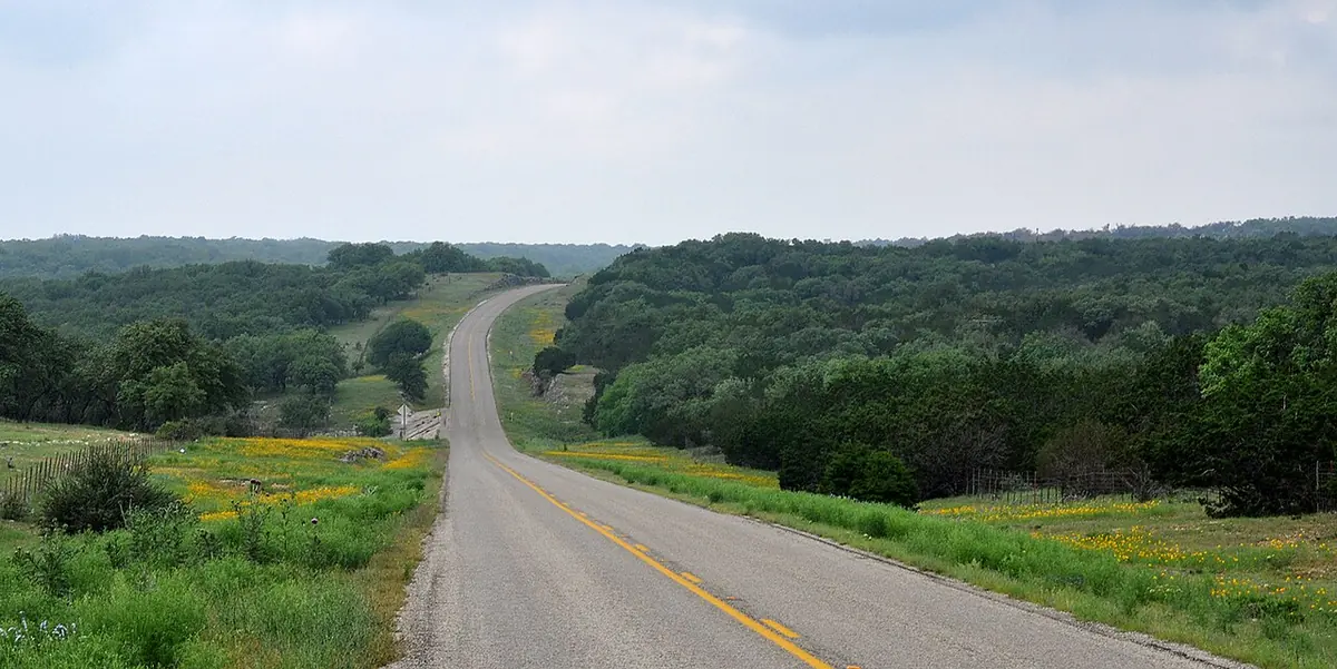 A rural highway winding through the Bandera County Hill Country